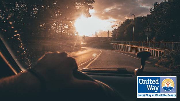 car driving on road toward sunset