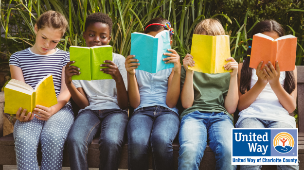 five children sitting together, reading books